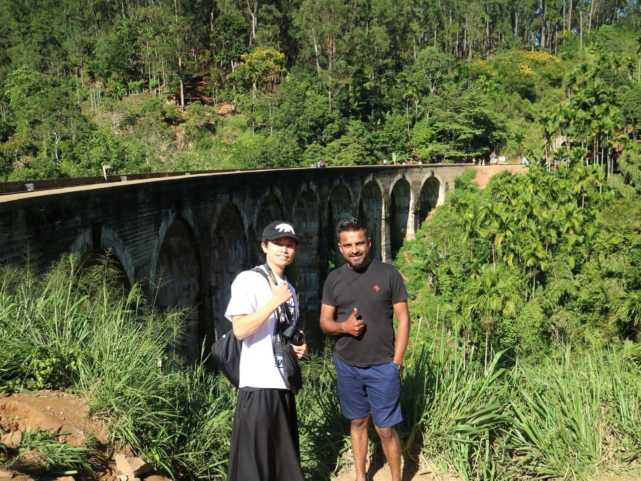 Travelers posing by the Nine Arches Bridge, Ella