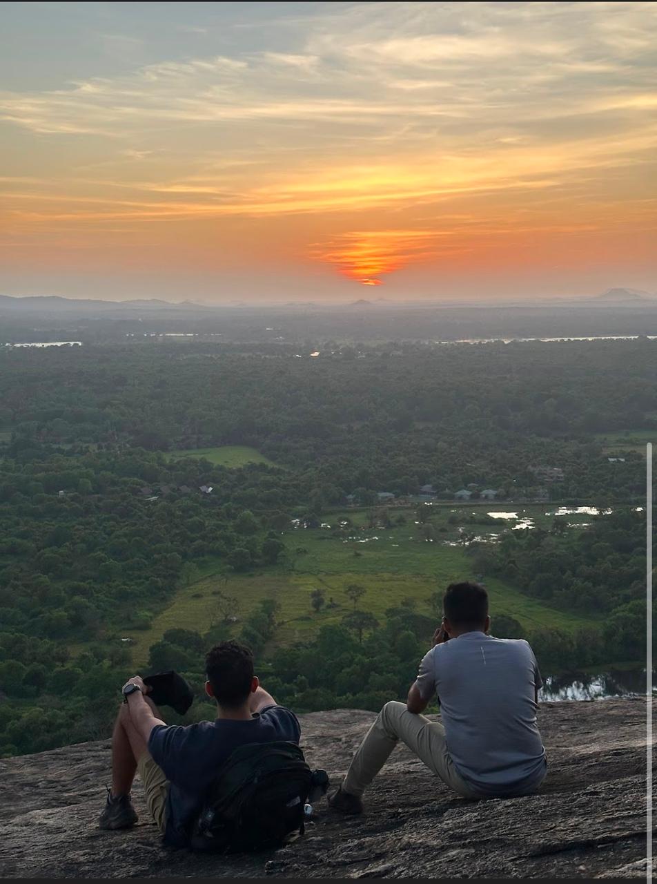 Travelers watching the sunset from Pidurangala Rock