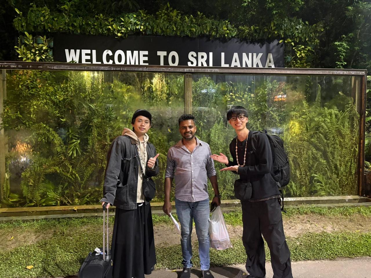 Travelers at the Welcome to Sri Lanka sign